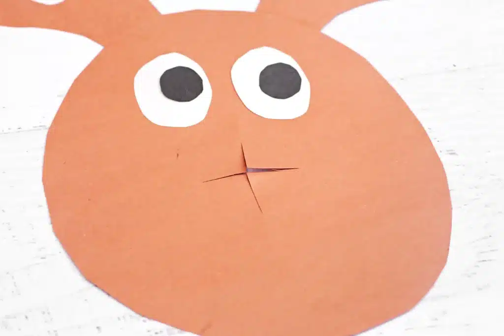 Rudolph Ring Pop Craft - Cultivating Brilliant Minds a reindeer craft made of construction paper with a cut out spot for the nose