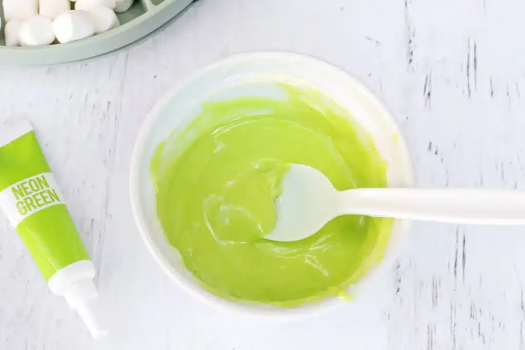 Grinch Hot Chocolate Spoons - Cultivating Brilliant Minds melted white chocolate dyed with green food coloring