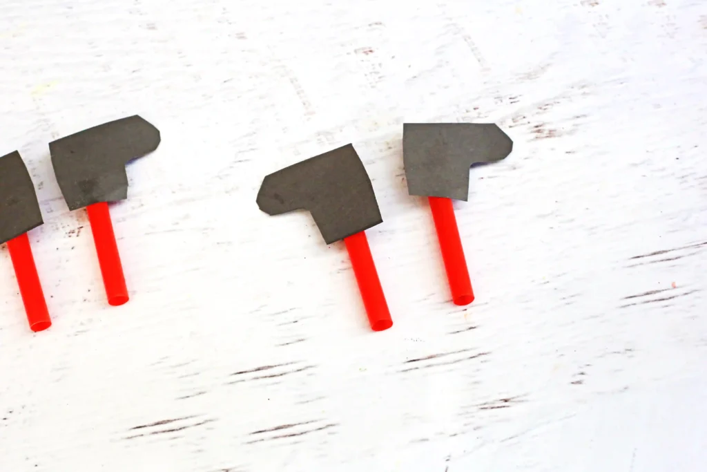 Santa in the Chimney Pudding Snack - Cultivating Brilliant Minds black construction paper boots glued onto straws