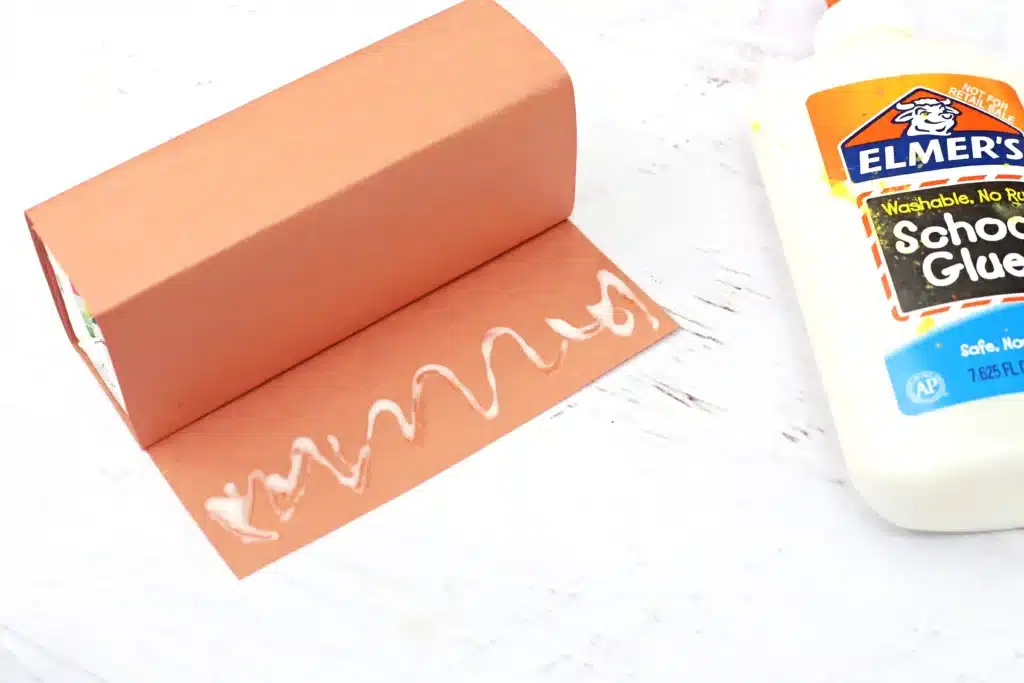 Rudolph Juice Boxes - Cultivating Brilliant Minds gluing the brown paper to the juice box