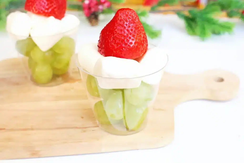 Grinch Fruit Cup - Cultivating Brilliant Minds a grinch fruit cup made with green grapes, mini marshmallows, and strawberries