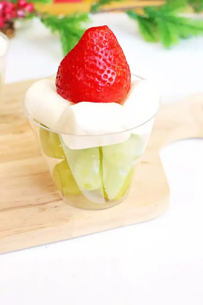 Grinch Fruit Cup - Cultivating Brilliant Minds a grinch fruit cup made with green grapes, mini marshmallows, and strawberries