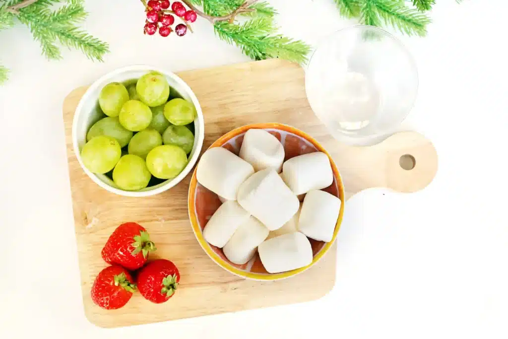 Grinch Fruit Cup - Cultivating Brilliant Minds clear cups, green grapes, mini marshmallows, and strawberries