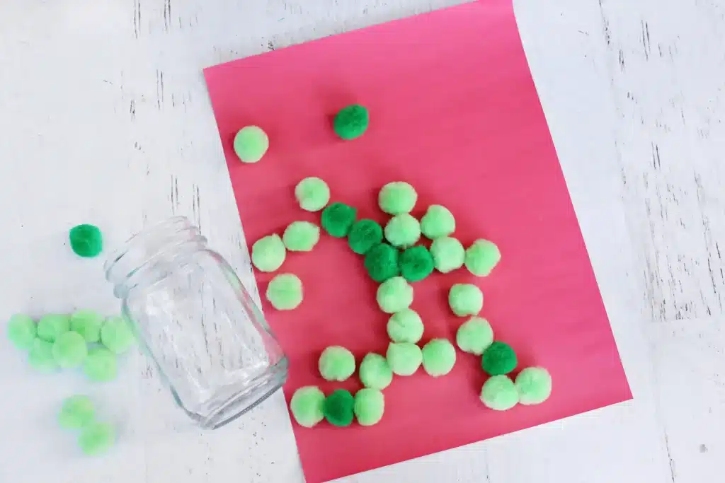 Grinch Heart Jar Challenge - Cultivating Brilliant Minds a mason jar, red construction paper, and green pom poms