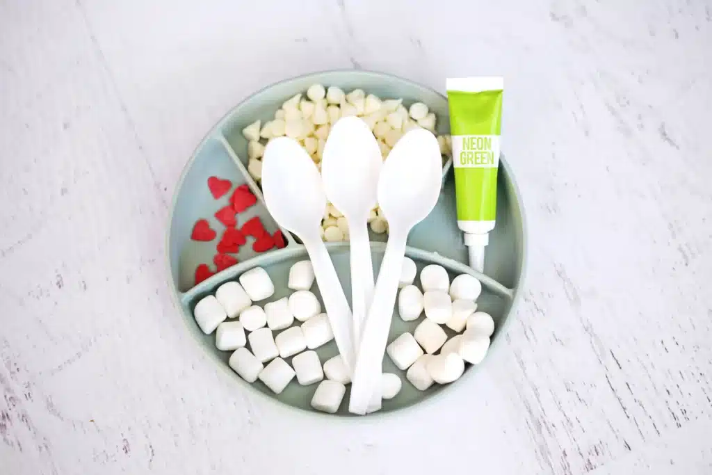 Grinch Hot Chocolate Spoons - Cultivating Brilliant Minds spoons, white chocolate, green food coloring, red candy hearts, and mini marshmallows