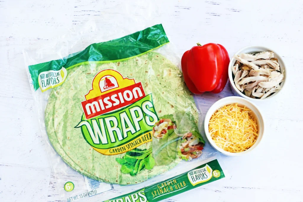 Grinch Quesadillas - Cultivating Brilliant Minds ingredients for the grinch quesadillas: spinach wraps, red pepper, chicken, and cheese