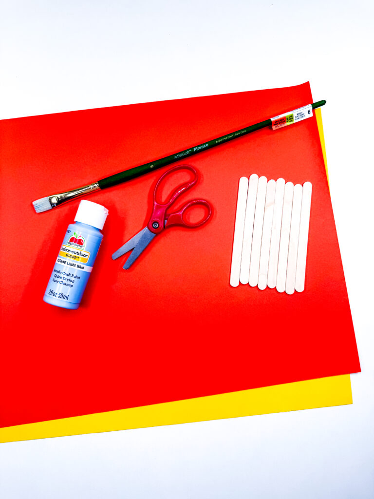 Menorah Craft - Cultivating Brilliant Minds orang and yellow construction paper, blue paint, scissors, paintbrush, and popsicle sticks