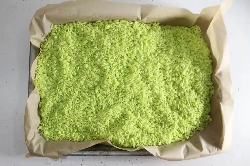 Grinch Sensory Bin - Cultivating Brilliant Minds rice dyed green with food coloring