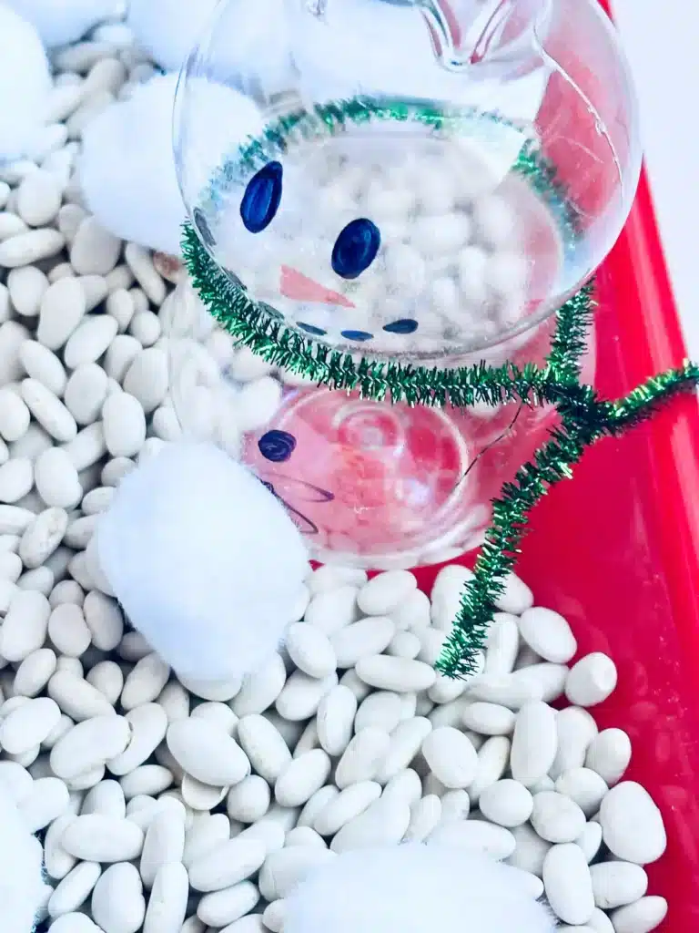 Snowman Sensory Bin - Cultivating Brilliant Minds a snowman sensory bin using beans and cotton balls