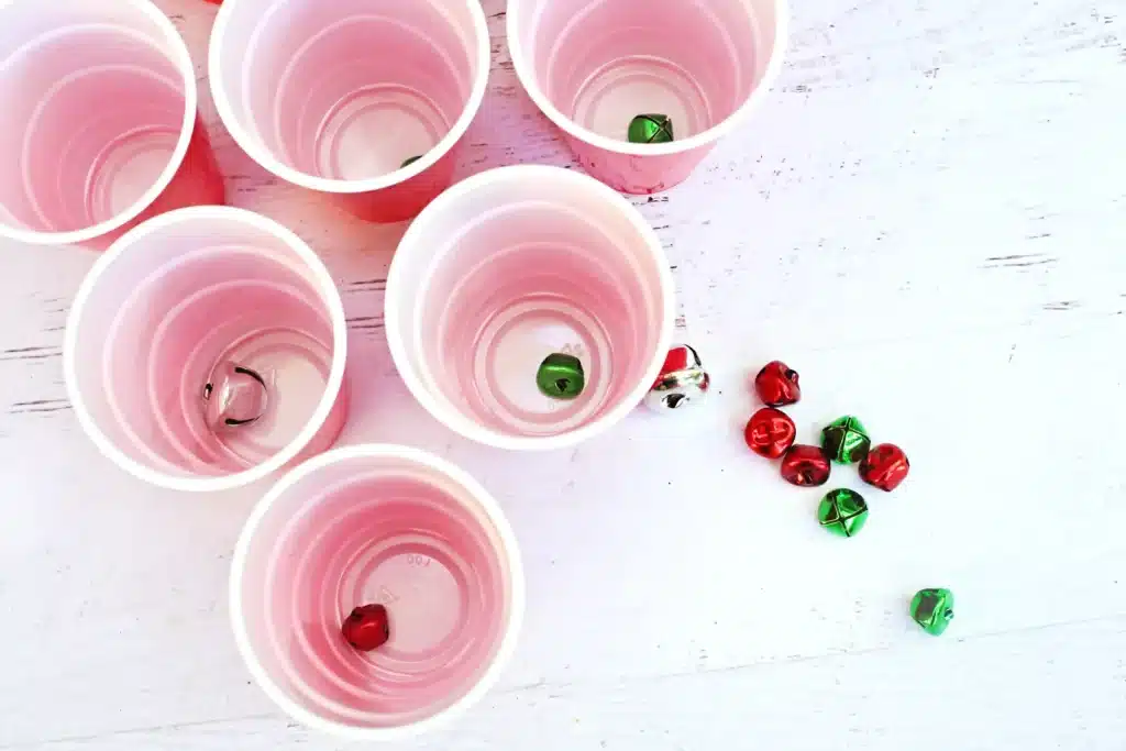 Jingle Bell Toss Reindeer Game - Cultivating Brilliant Minds red cups with jingle bells in them