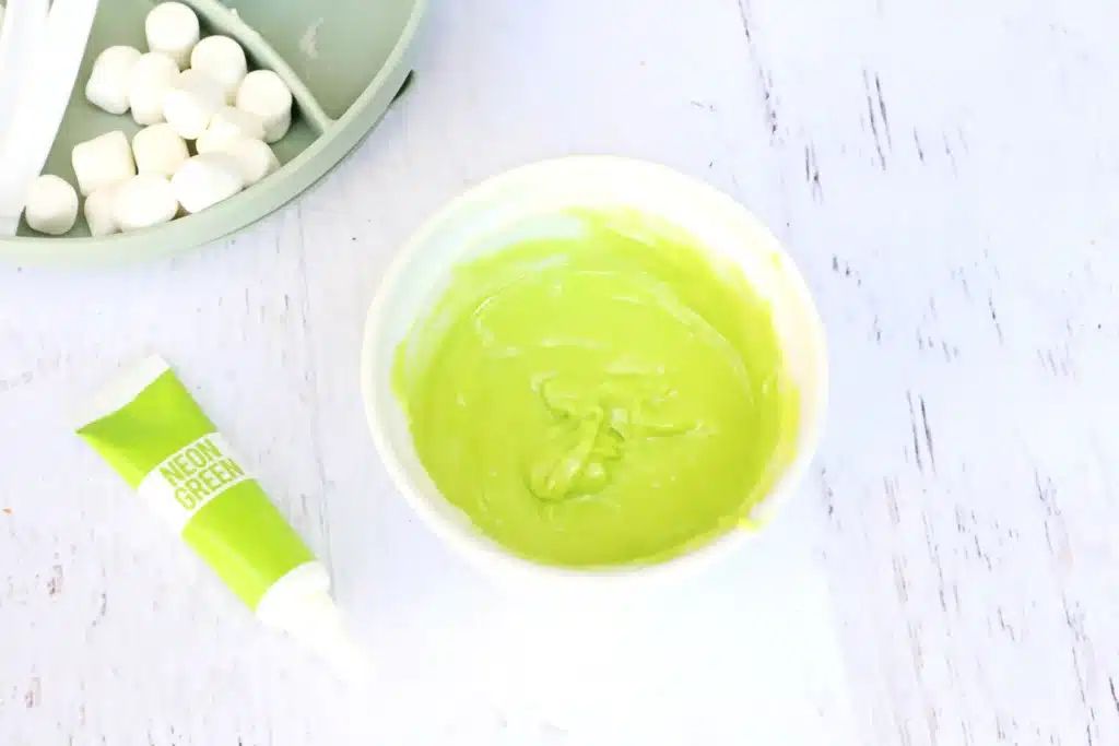 Grinch Hot Chocolate Spoons - Cultivating Brilliant Minds melted white chocolate dyed with green food coloring