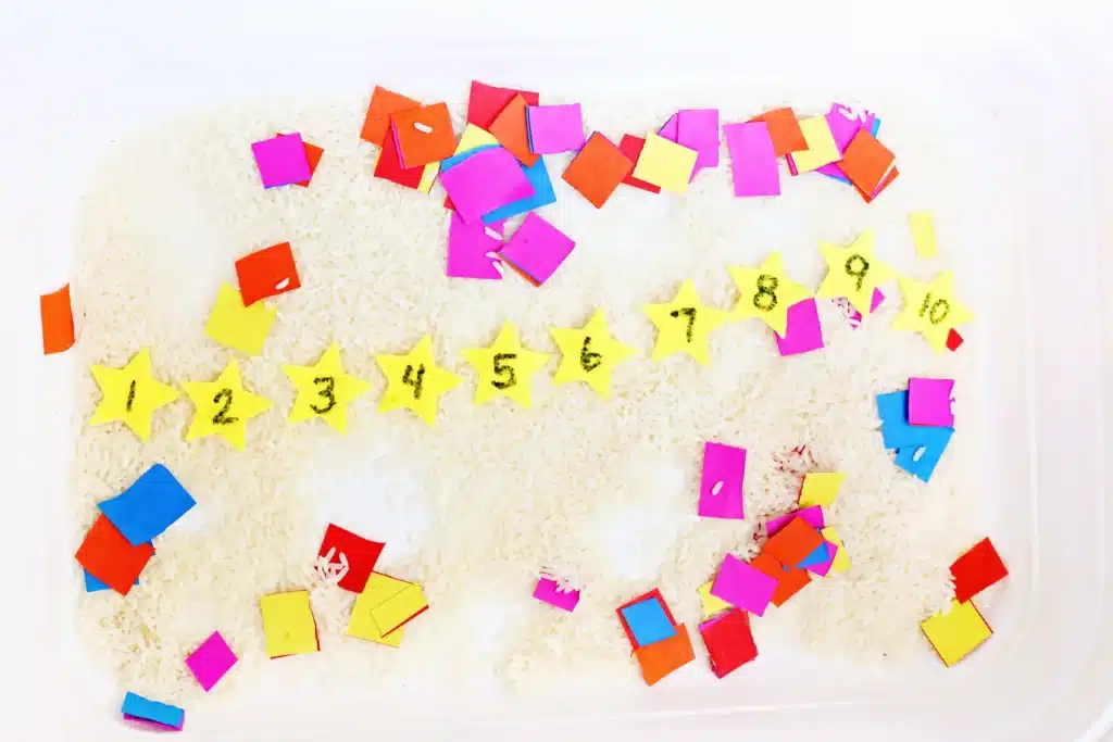 New Year's Countdown Star Hunt Bin - Cultivating Brilliant Minds New Year's Countdown Star Hunt Bin: a rice sensory bin filled with countdown stars to countdown the new year