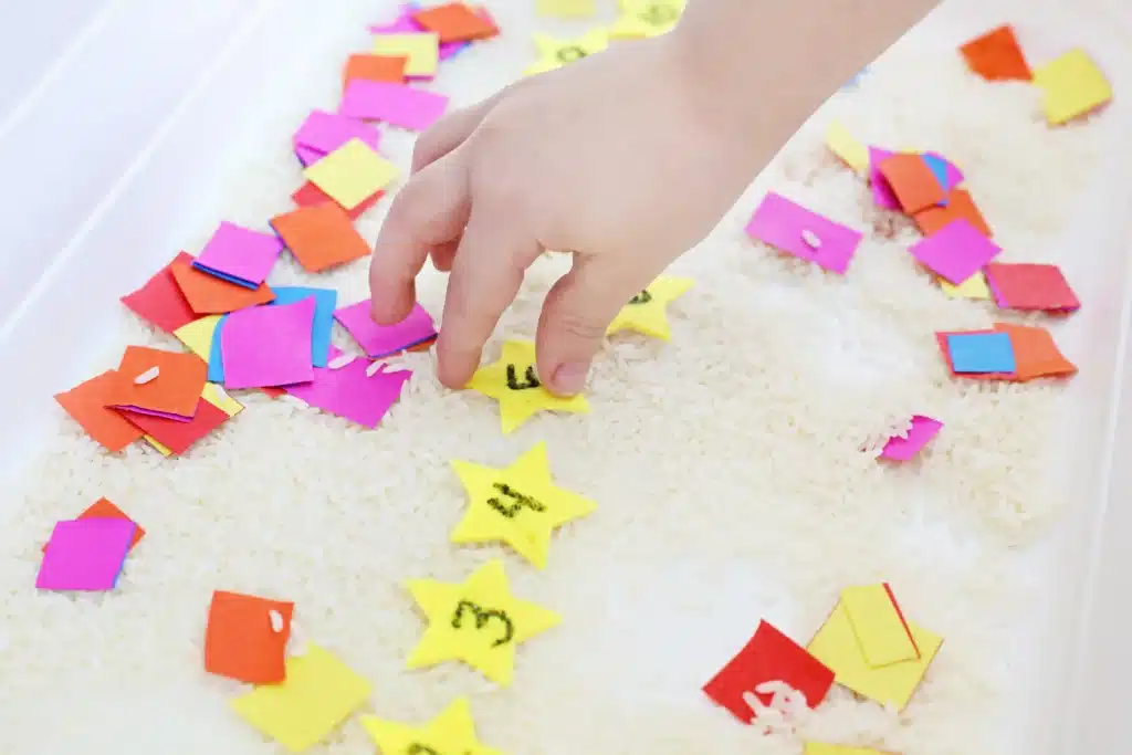 New Year's Countdown Star Hunt Bin: a rice sensory bin filled with countdown stars to countdown the new year