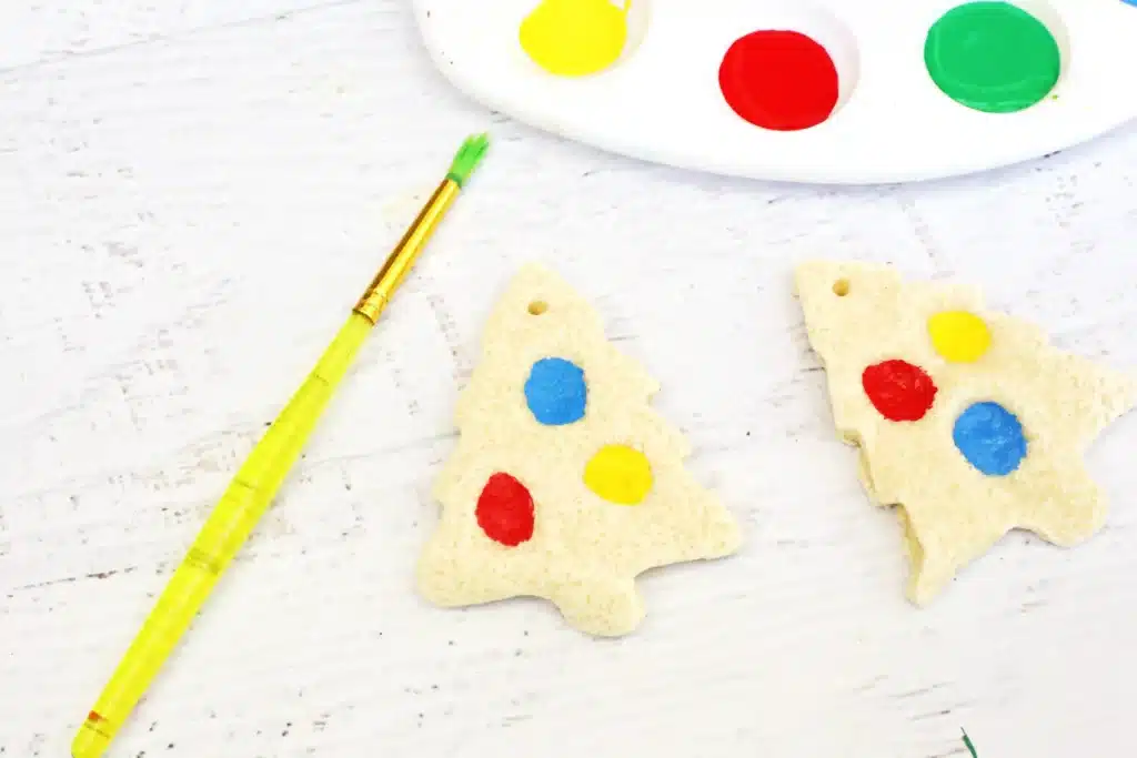 Fingerprint Salt Dough Christmas Tree Ornament - Cultivating Brilliant Minds red, blue, and yellow ornaments painted on the salt dough christmas tree