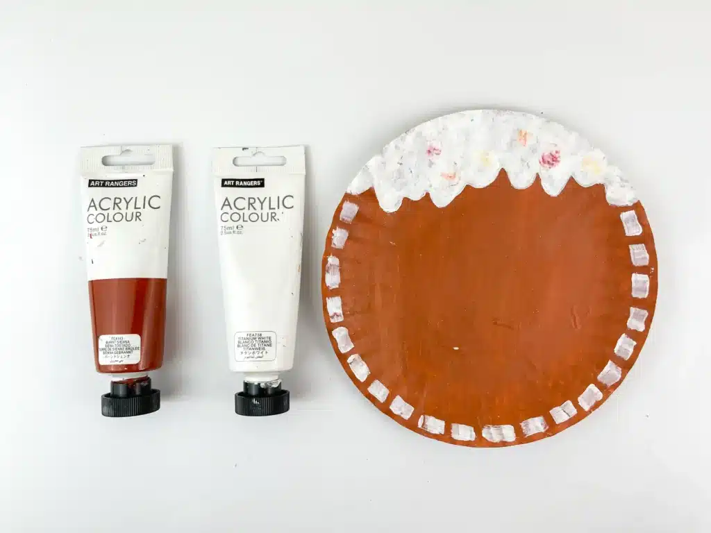 Gingerbread Paper Plate Craft - Cultivating Brilliant Minds a paper plate painted brown with white painted dots are the endge and scalloped at the top to look like icing