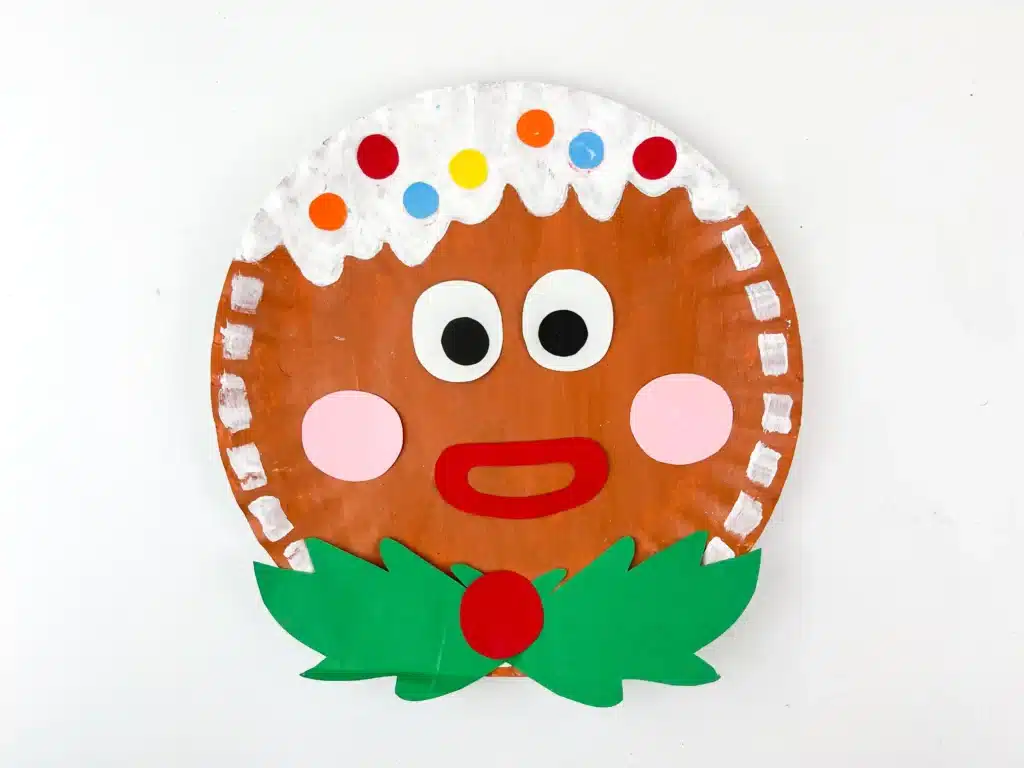 Gingerbread Paper Plate Craft - Cultivating Brilliant Minds a paper plate decorated to look like a gingerbread