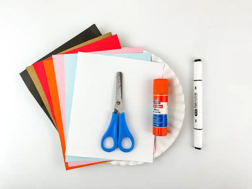 Melted Snowman Paper Plate Craft - Cultivating Brilliant Minds construction paper, paper plate, scissors, glue, and a black marker