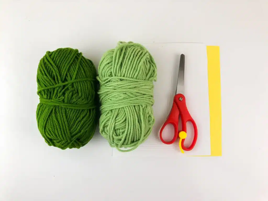 Yarn Ornament For Christmas - Cultivating Brilliant Minds green yarn in 2 shades, scissors, and yellow construction paper