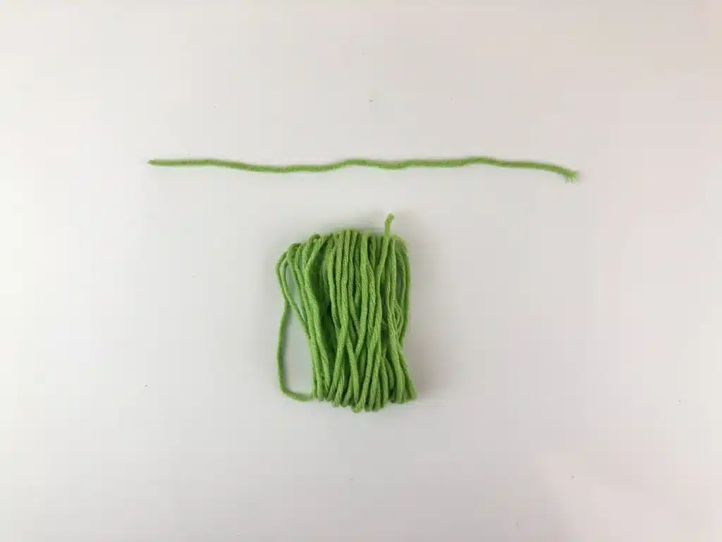 Yarn Ornament For Christmas - Cultivating Brilliant Minds the spool of yarn on the table