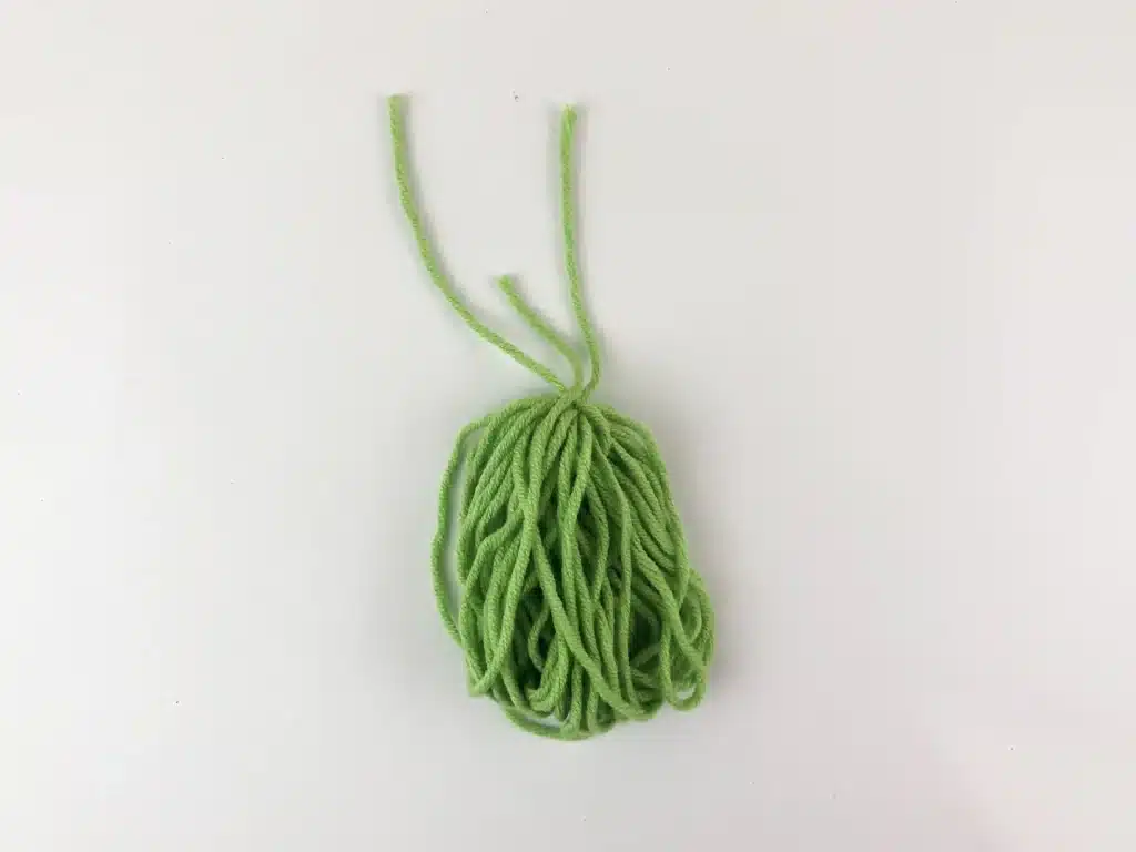 Yarn Ornament For Christmas - Cultivating Brilliant Minds the yarn with a string tied around it to hold it