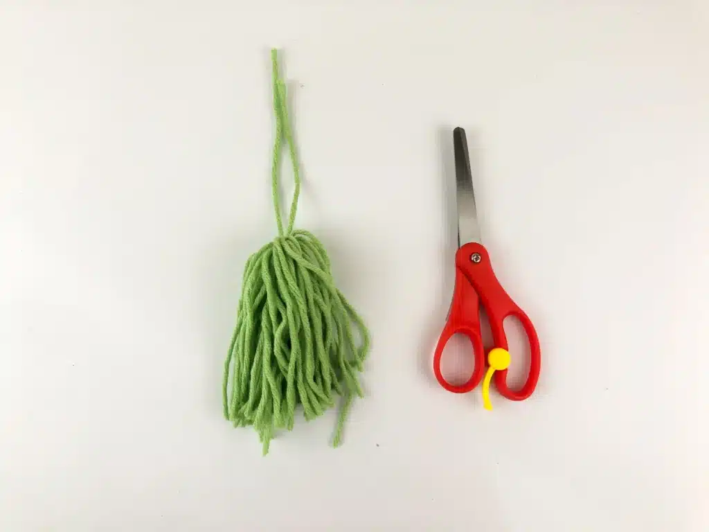 Yarn Ornament For Christmas - Cultivating Brilliant Minds cut the yarn with scissors so it looks like a tassel