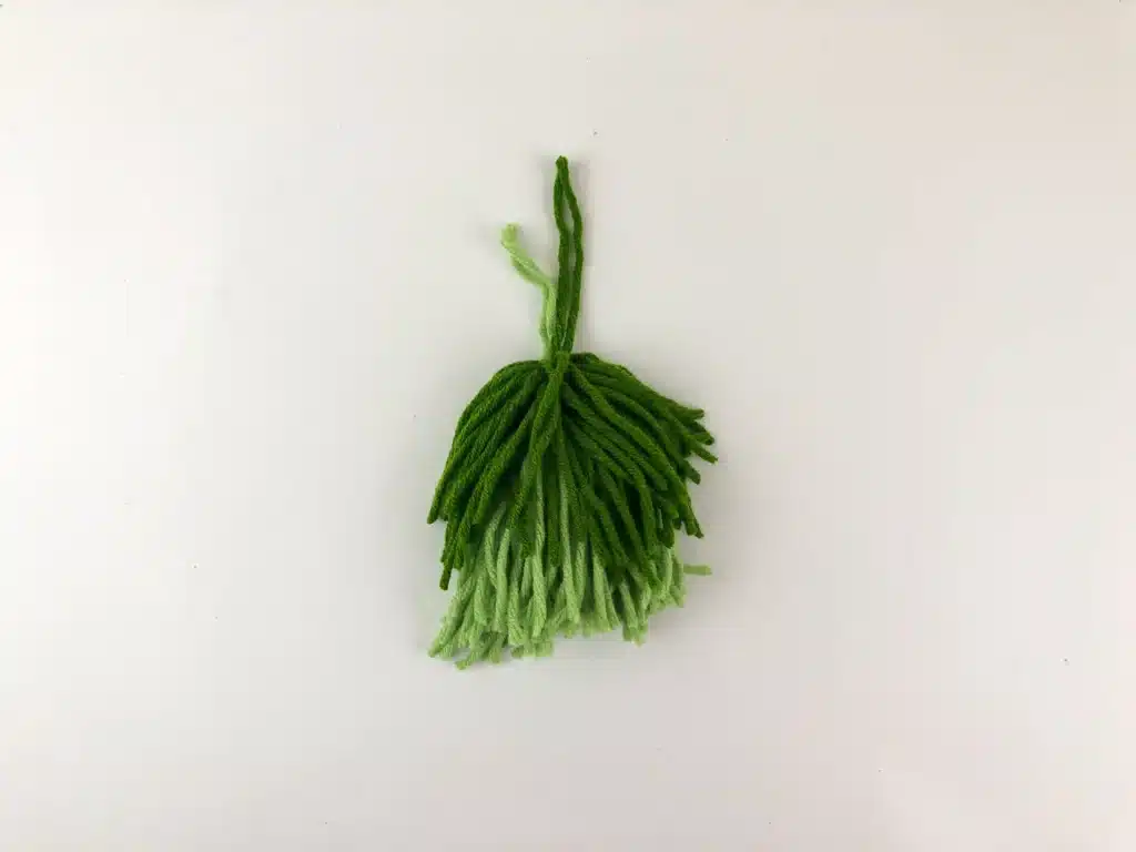 Yarn Ornament For Christmas - Cultivating Brilliant Minds the two yarn tassels tied together