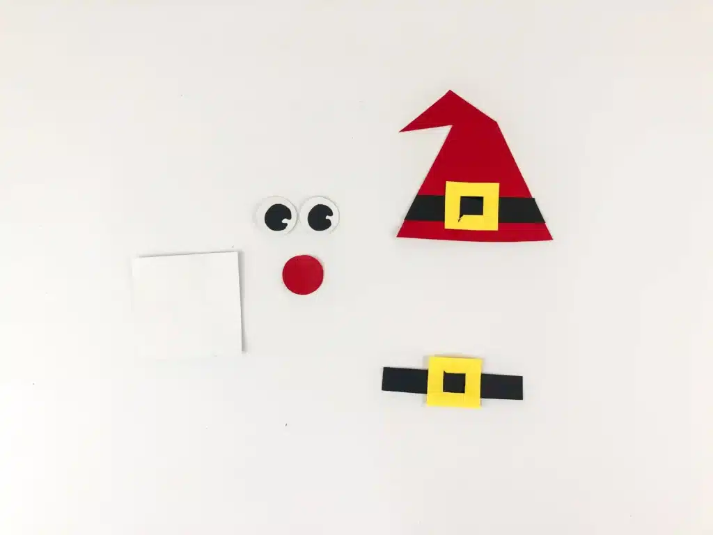 Santa Popsicle Stick Ornament Craft - Cultivating Brilliant Minds santa face, hat, and belt cut out of construction paper