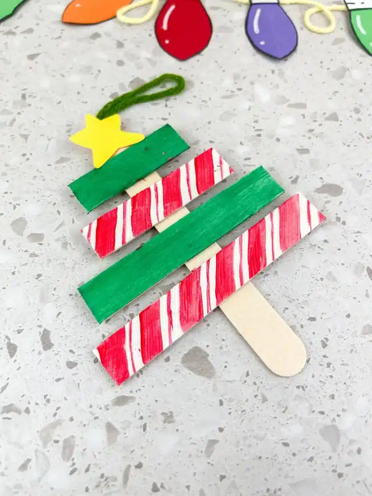 Christmas Tree Popsicle Stick Ornament - Cultivating Brilliant Minds popsicle sticks organized and decorated to look like a christmas tree