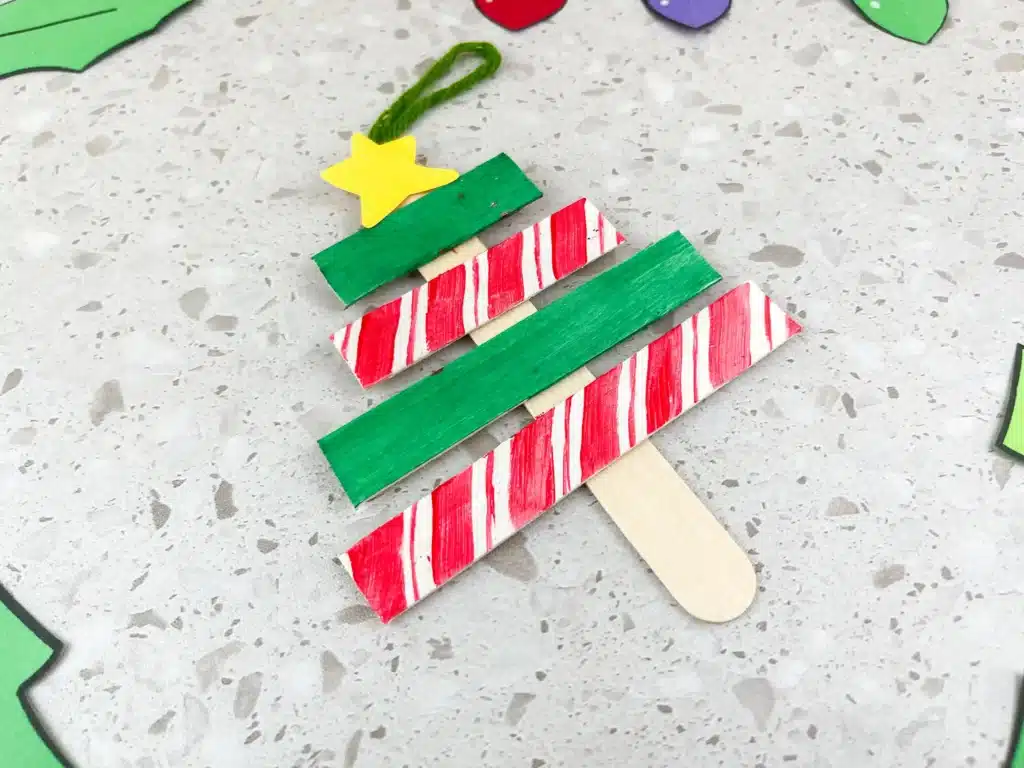 Christmas Tree Popsicle Stick Ornament - Cultivating Brilliant Minds popsicle sticks organized and decorated to look like a christmas tree
