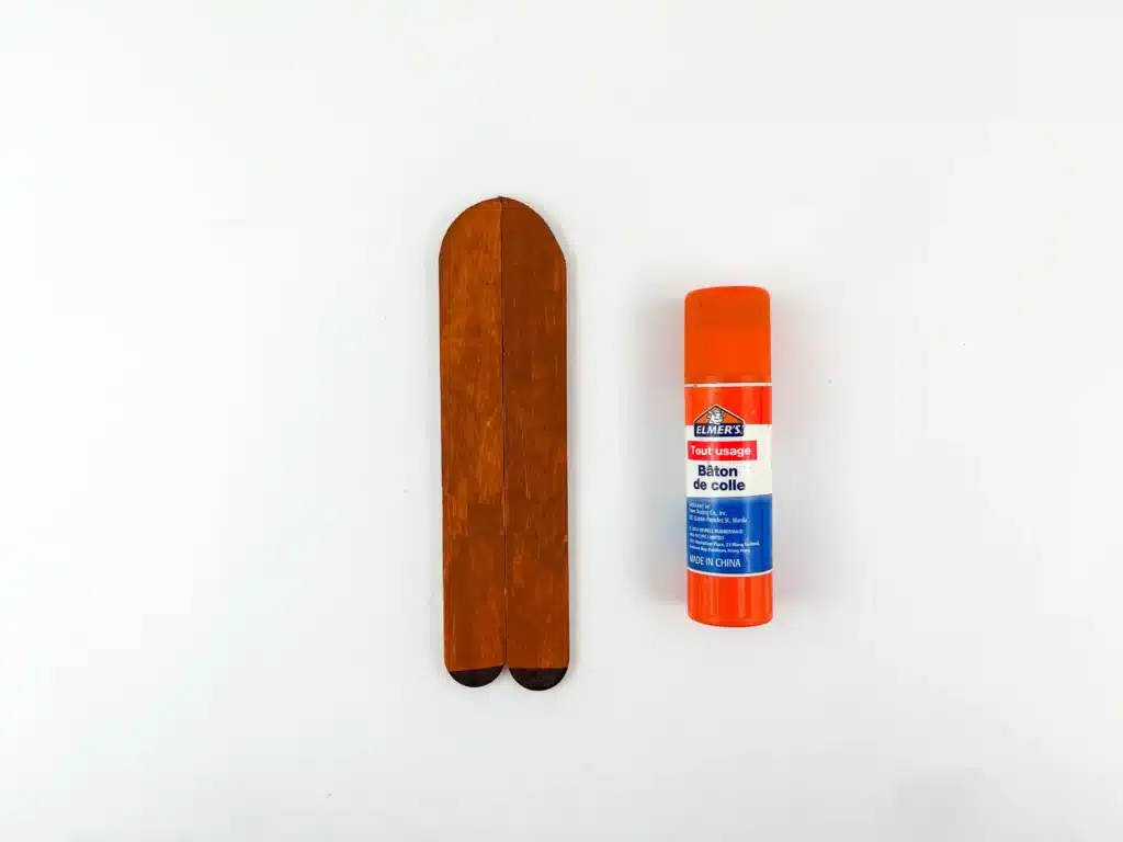 Reindeer Popsicle Stick Ornament Craft - Cultivating Brilliant Minds popsicle sticks painted brown and cut to resemble an arch