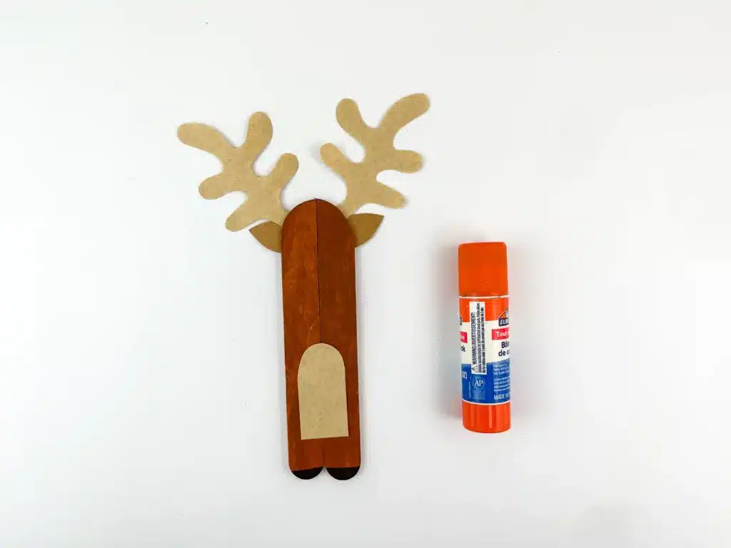 Reindeer Popsicle Stick Ornament Craft - Cultivating Brilliant Minds popsicle sticks glued together and decorated to look like a reindeer