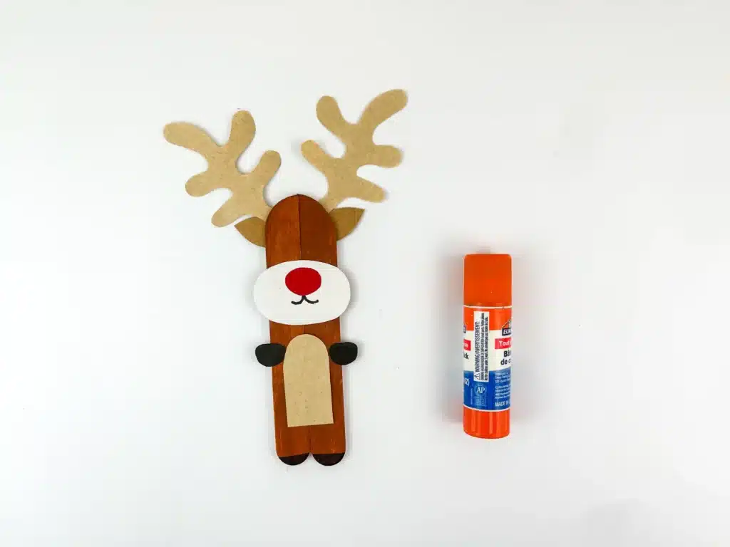Reindeer Popsicle Stick Ornament Craft - Cultivating Brilliant Minds popsicle sticks glued together and decorated to look like a reindeer