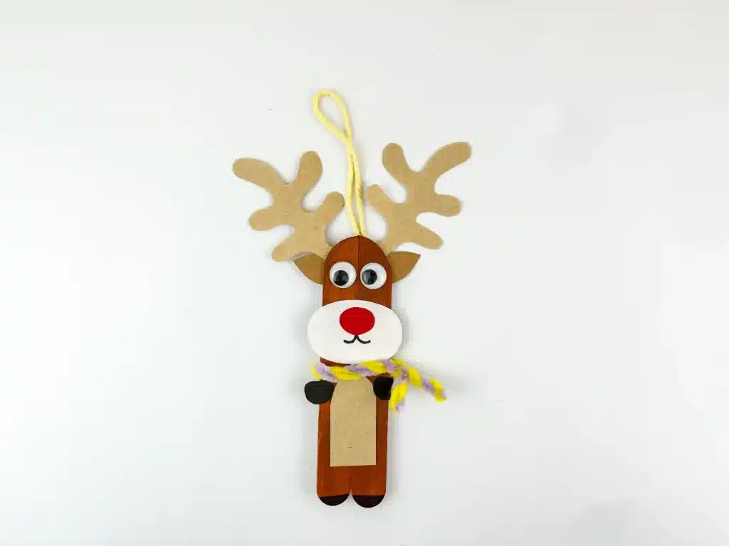 Reindeer Popsicle Stick Ornament Craft - Cultivating Brilliant Minds popsicle sticks glued together and decorated to look like a reindeer