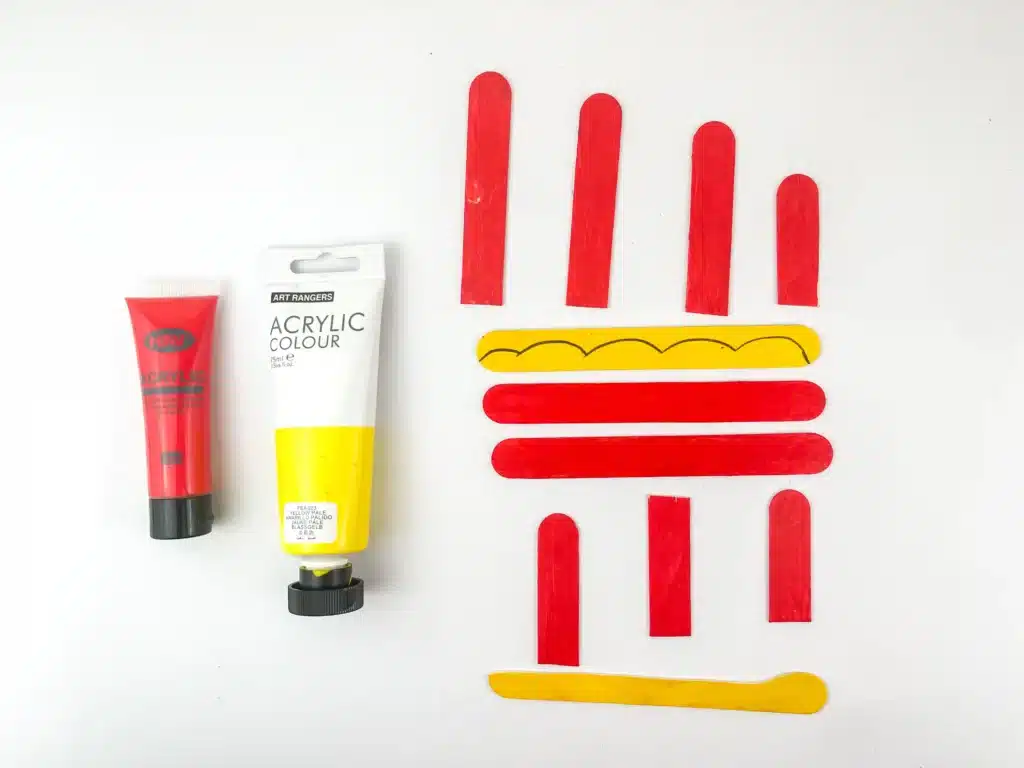Santa Sleigh Craft - Cultivating Brilliant Minds popsicle sticks painted red and yellow