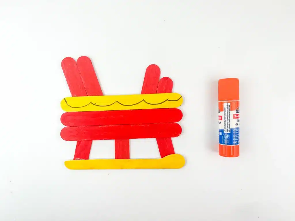 Santa Sleigh Craft - Cultivating Brilliant Minds a santa sleigh made out of painted popsicle sticks