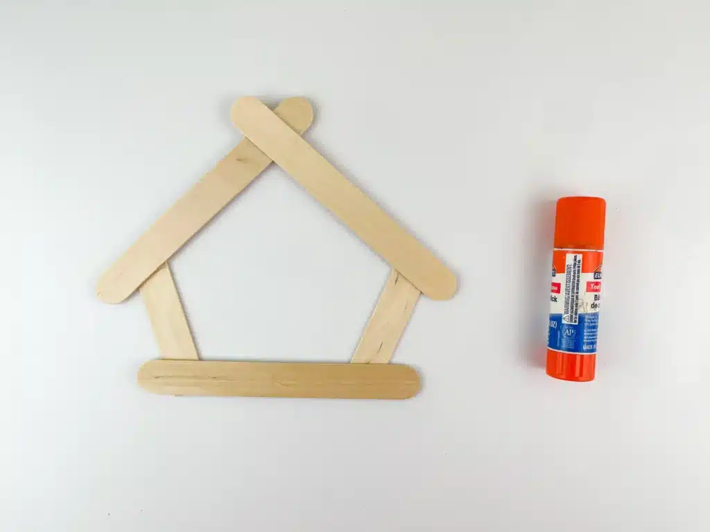 Nativity Popsicle Stick Craft - Cultivating Brilliant Minds popsicle sticks glued together to look like a manger