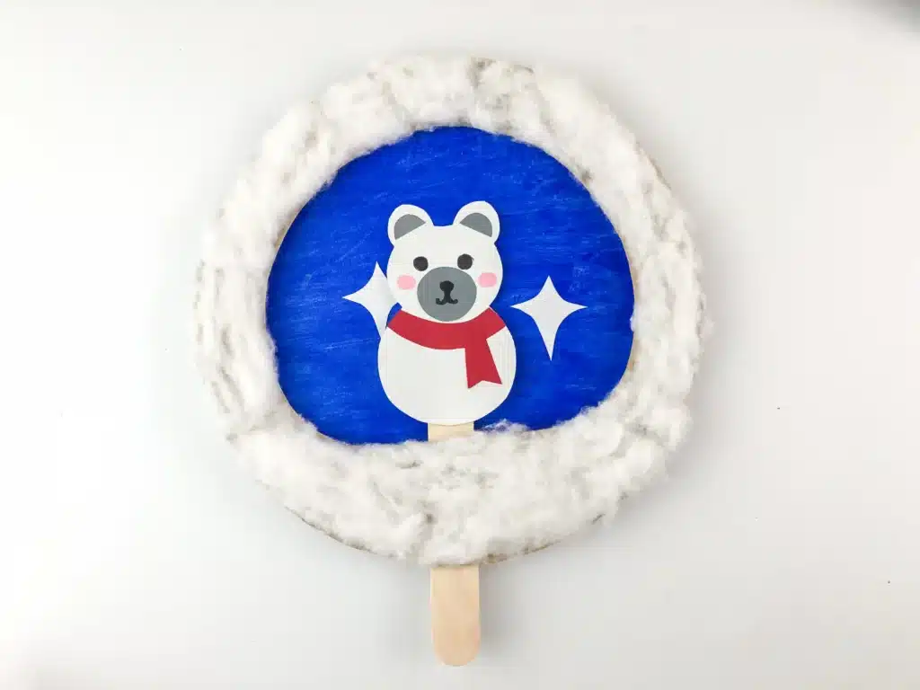 Moving Polar Bear Craft - Cultivating Brilliant Minds a paper plate craft with a polar bear attached to a popsicle stick so it can move back and forth