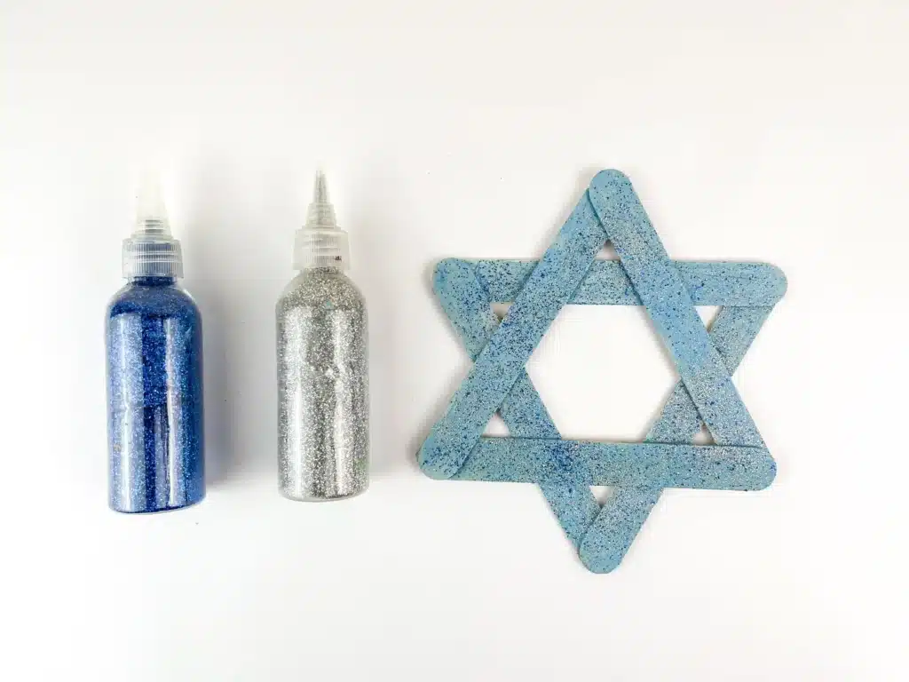 Star of David Craft - Cultivating Brilliant Minds blue popsicle sticks with blue and silver glitter glued together to look like the star of david