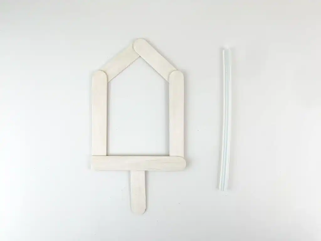 Dreidel Craft for Hanukkah - Cultivating Brilliant Minds popsicle sticks glued together to look like a dreidel