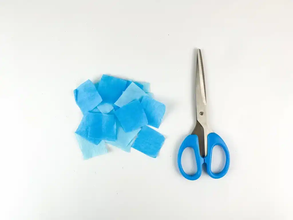 Dreidel Craft for Hanukkah - Cultivating Brilliant Minds blue japanese paper cut into squares