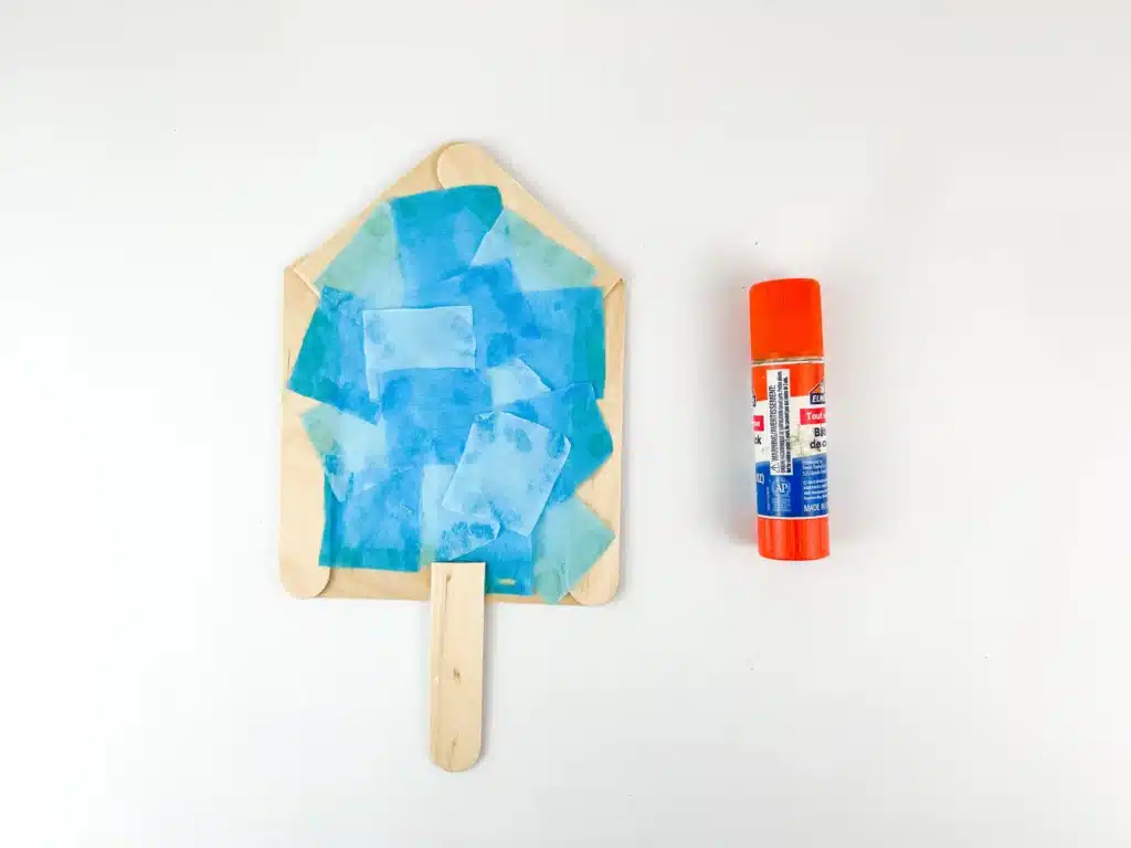 Dreidel Craft for Hanukkah - Cultivating Brilliant Minds blue japanese paper glued onto the popsicle stick dreidel