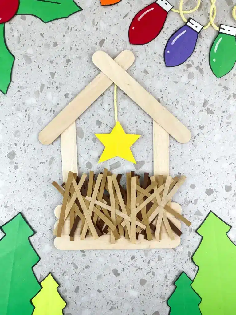 a manger made out of popsicle sticks and construction paper