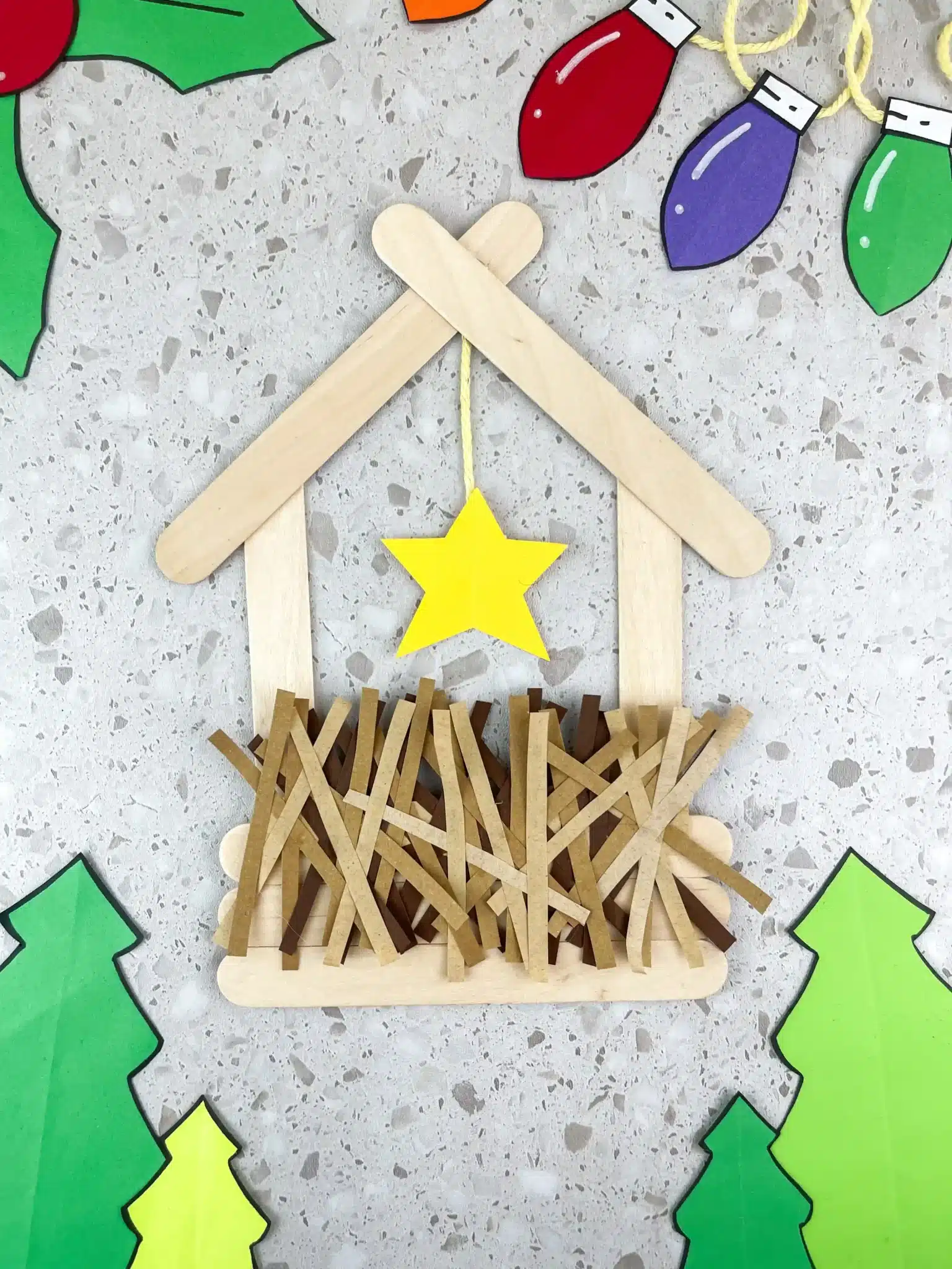 a manger made out of popsicle sticks and construction paper