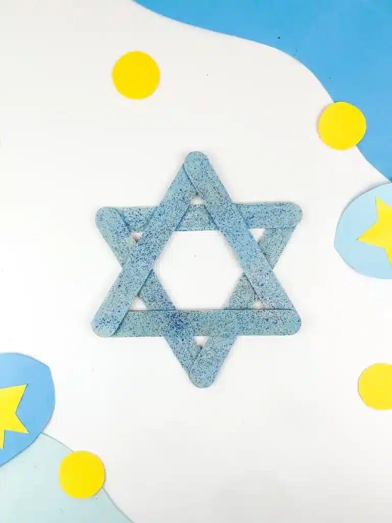 Star of David Craft - Cultivating Brilliant Minds blue popsicle sticks with blue and silver glitter glued together to create the star of david craft