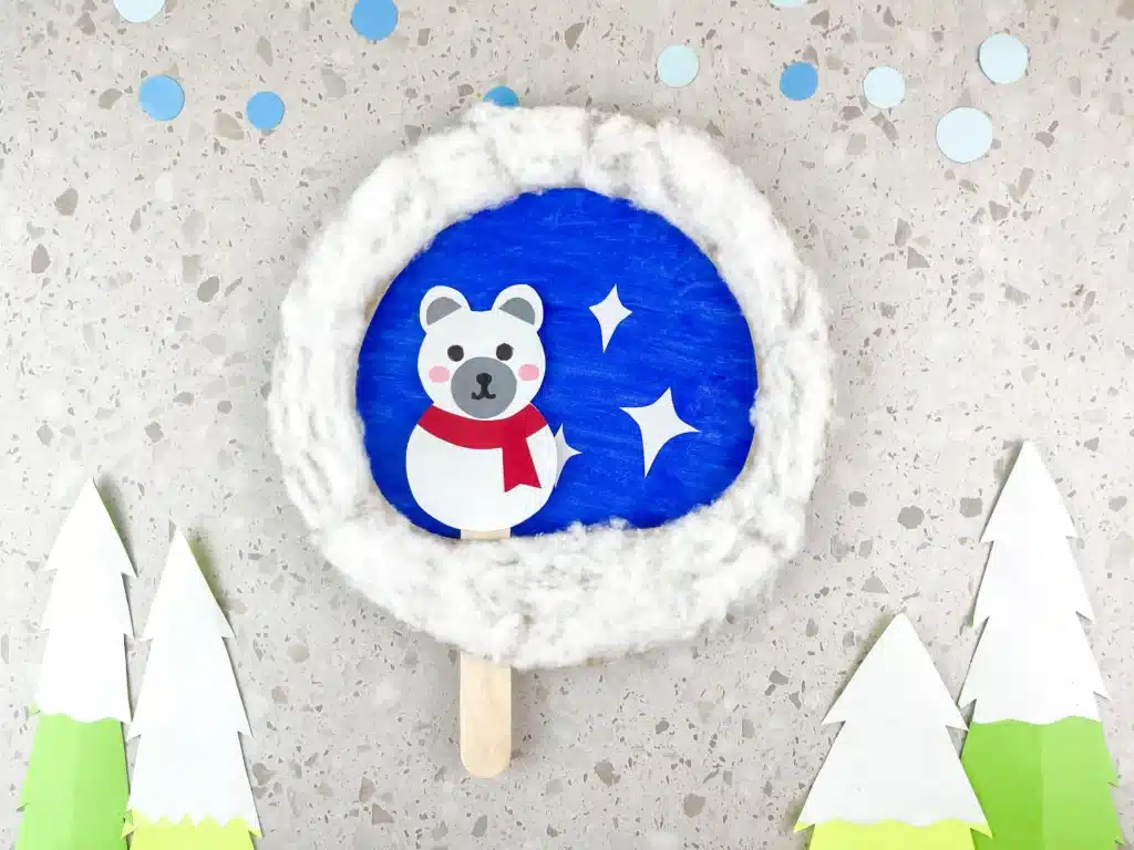 Moving Polar Bear Craft - Cultivating Brilliant Minds a paper plate craft with a polar bear attached to a popsicle stick so it can move back and forth