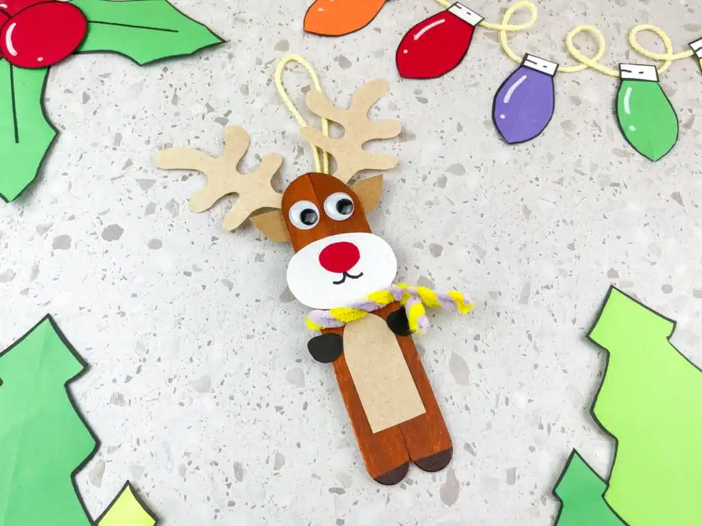 Reindeer Popsicle Stick Ornament Craft - Cultivating Brilliant Minds popsicle sticks glued together and decorated to look like a reindeer