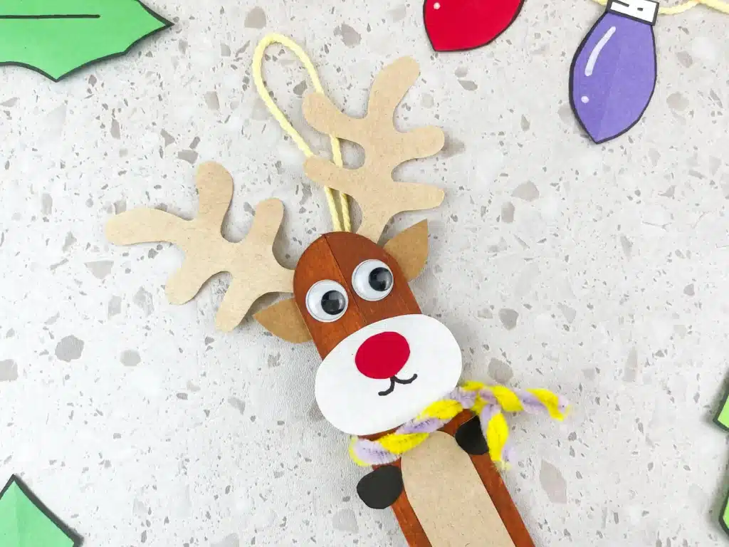 Reindeer Popsicle Stick Ornament Craft - Cultivating Brilliant Minds popsicle sticks glued together and decorated to look like a reindeer