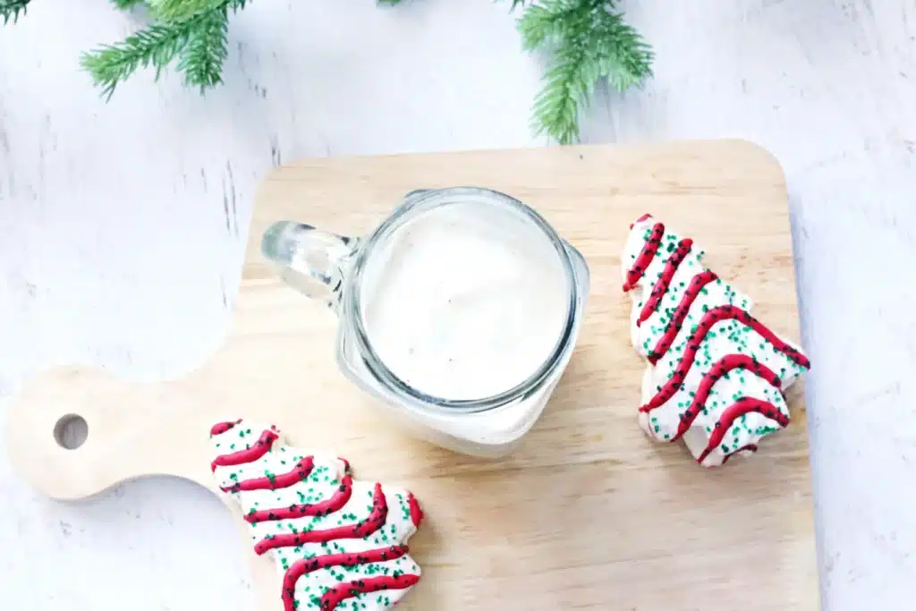 Christmas Tree Cake Milkshake - Cultivating Brilliant Minds vanilla ice cream in a mug next to little debbies christmas trees