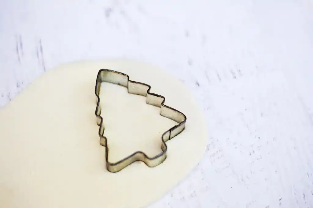 Fingerprint Salt Dough Christmas Tree Ornament - Cultivating Brilliant Minds salt dough with a christmas tree cookie cutter on top