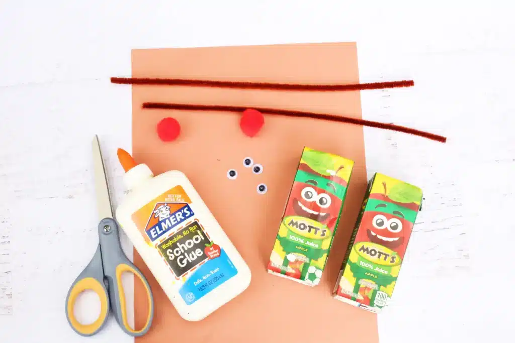 Rudolph Juice Boxes - Cultivating Brilliant Minds brown paper, scissors, glue, googly eyes, juice boxes, red pom poms and brown pipe cleaners